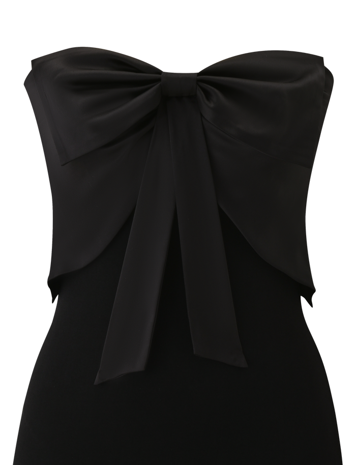 The GROVE MINI DRESS - BLACK by TIGERMIST is a strapless mini dress with a striking satin bow at the chest, giving this classic little black dress a stylish modern update.