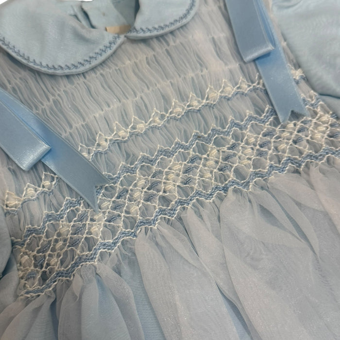 Close-up of delicate handsmocking on Hansen Light Blue Romper
