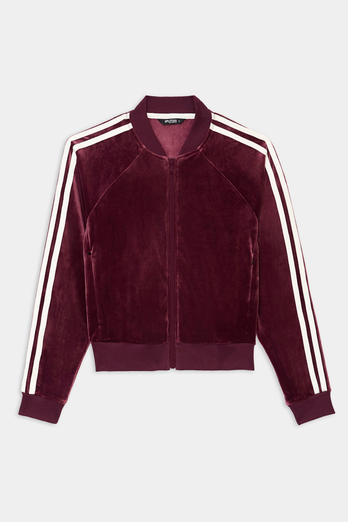 The SPLITS59 Heritage Velour Bomber in Dark Cherry/White features a zip-up design with white double stripes on the sleeves and ribbed collar, cuffs, and hem.