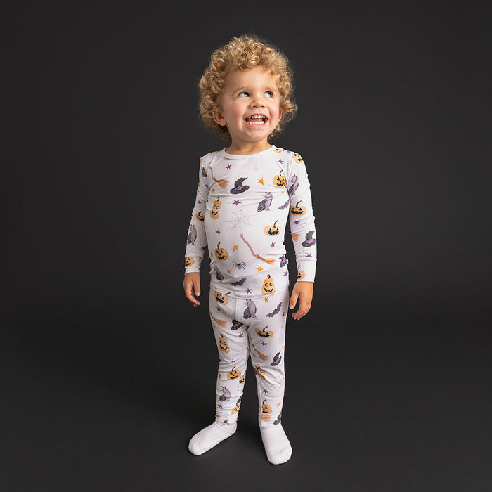Child standing wearing the Posh Peanut Irving Classic Pajama Set.