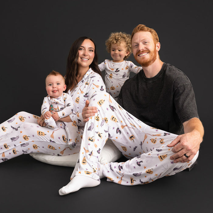 A family sitting together, with a parent and baby wearing matching Posh Peanut Irving prints.