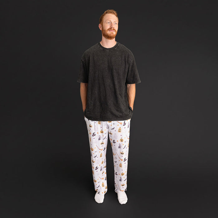 Man standing wearing the Posh Peanut Irving Men's Pajama Pants and a black t-shirt.