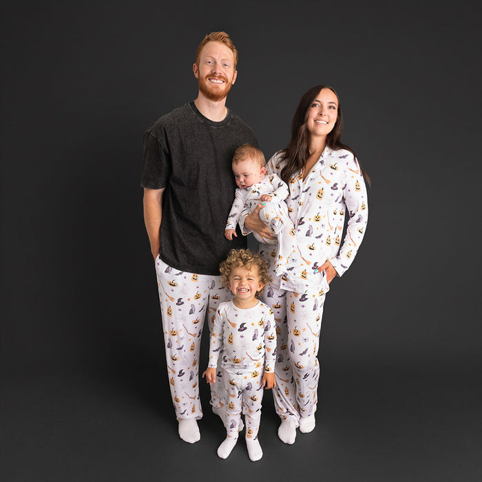 A family standing together, wearing coordinating Posh Peanut Irving pajamas.