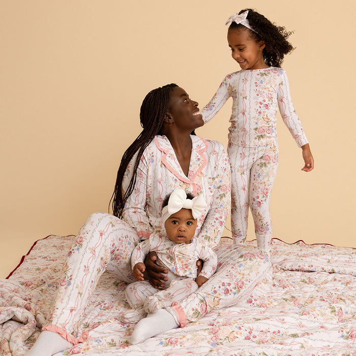 Mother and daughter sitting together in matching Janey print pajama sets