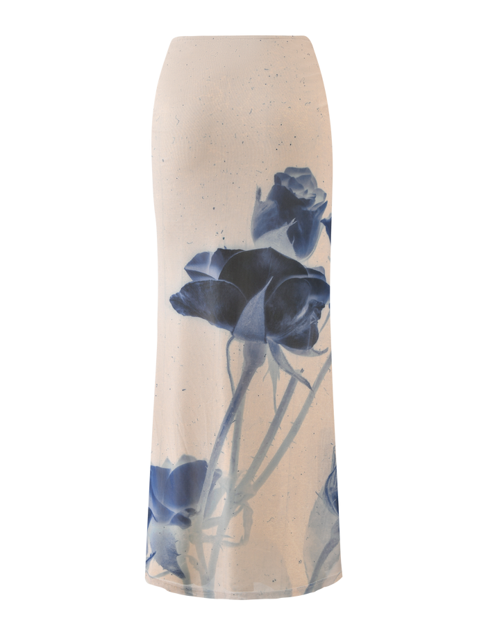 The JANIS MAXI SKIRT by TIGERMIST features a bold indigo floral print with large blue roses, stems, and leaves on white fabric.