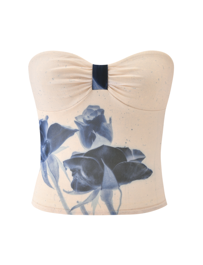 The JANIS TOP - INDIGO FLORAL by TIGERMIST is a cream strapless tube top with a ruched center and bold blue rose print, crafted from delicate floral mesh for texture.