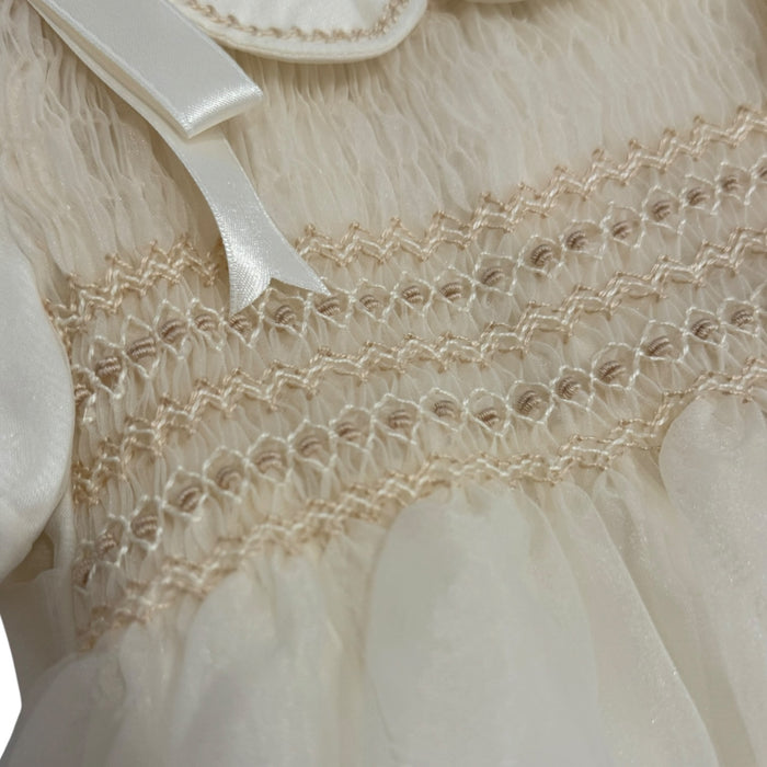 Close-up of ivory handsmocking across the chest on Kenneth Romper