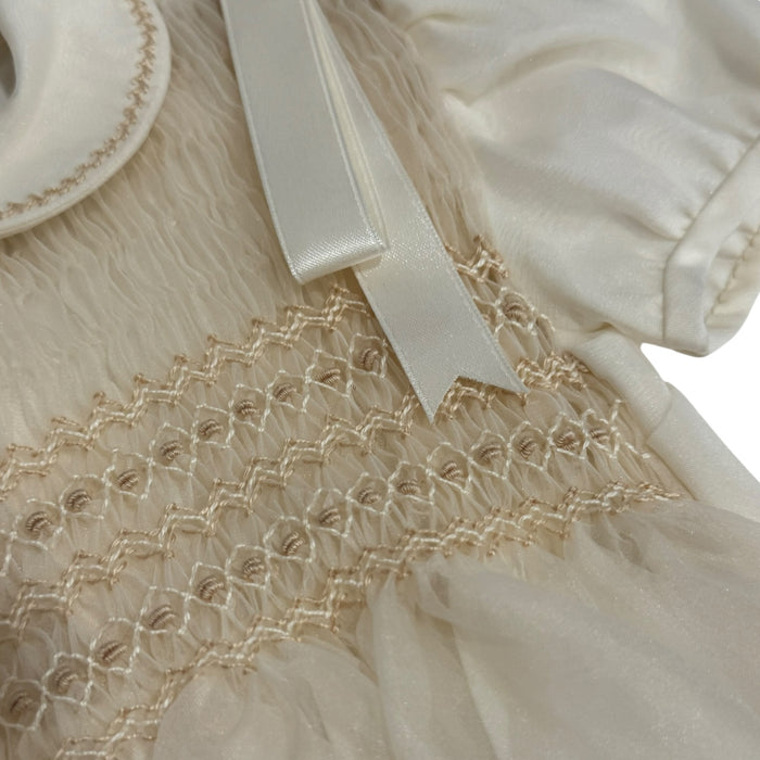 Close-up of rounded collar and tonal smocking on Kenneth Ivory Romper