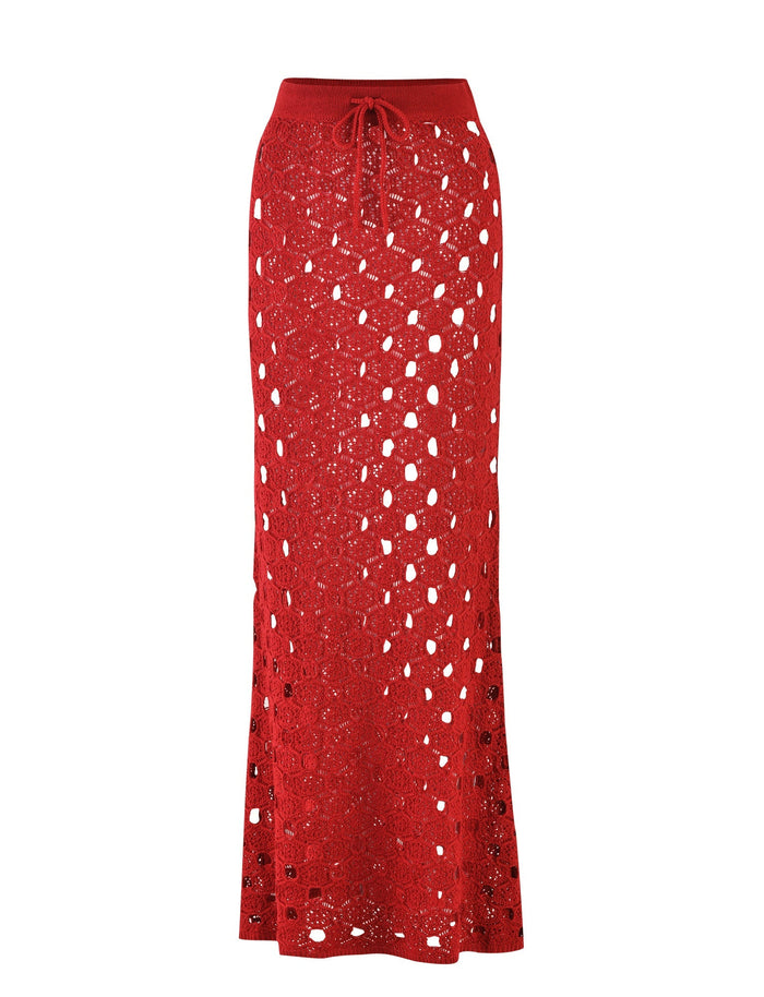 Introducing the KINCADE SKIRT - RED: CHERRY RED from TIGERMIST, a long red crocheted skirt featuring a drawstring waistband. This exquisite design boasts large open hole patterns for a semi-sheer, airy look, complemented by textured fabric that adds depth to its overall appearance.