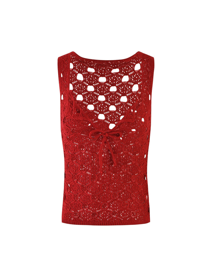 The KINCADE TOP - RED by TIGERMIST is a vibrant crochet tank top in cherry red, featuring an intricate pattern with a V-neckline. It boasts a tied string detail at the center of the chest and has a slightly scalloped hem. The crochet design showcases an array of circular and floral motifs.