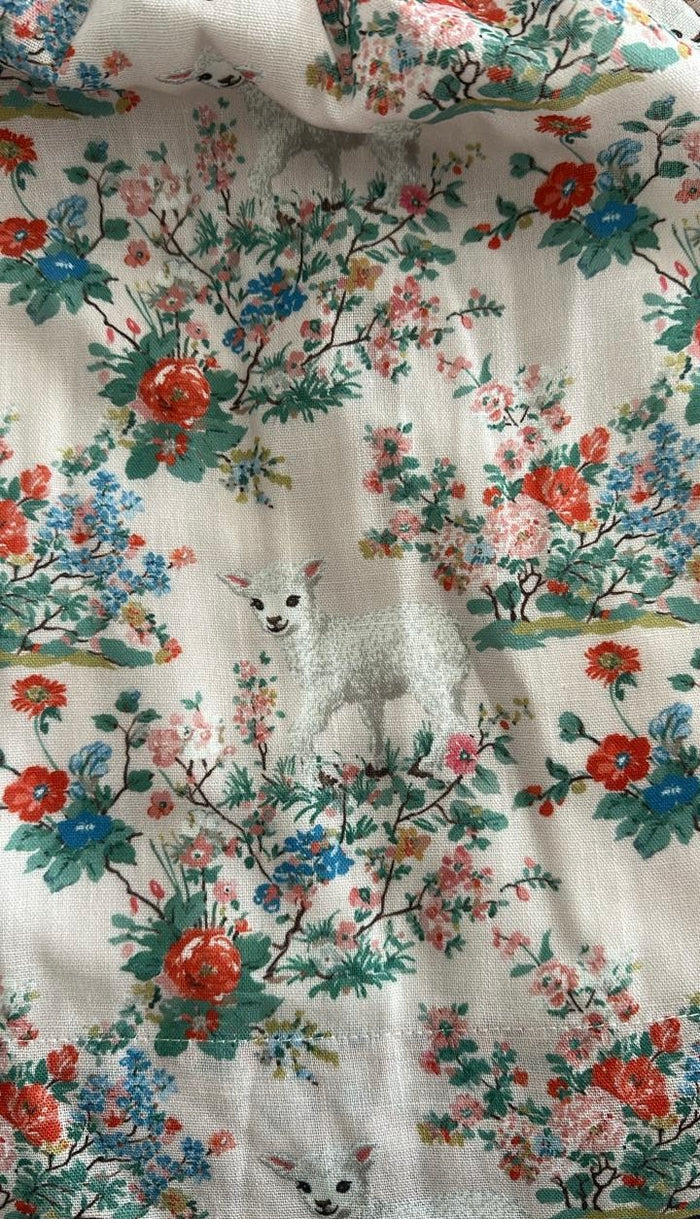 Close-up of floral and lamb print on Lamb Red Floral Handsmocked Dress