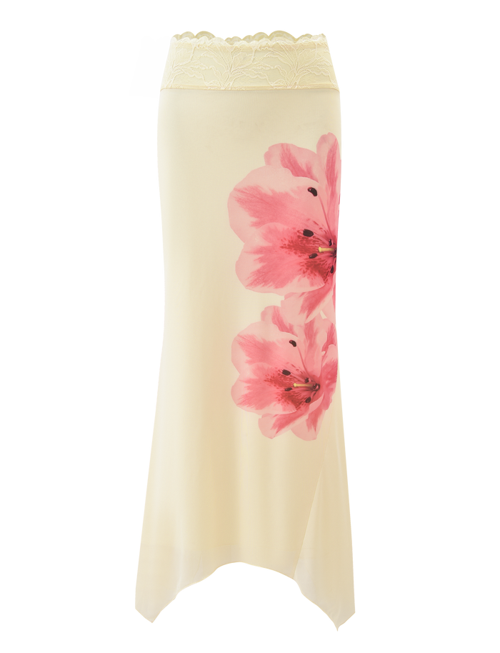 The LILLIAN SKIRT - YELLOW by TIGERMIST is a cream floral skirt with a lace-trim waistband, two large pink blooms on the side, and an asymmetrical hem for a soft, flowing look.