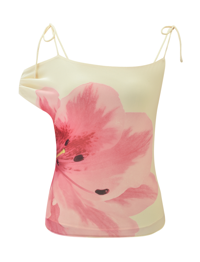 The LILLIAN TOP by TIGERMIST is a yellow spaghetti strap camisole adorned with a bold, vibrant pink floral design on the front.