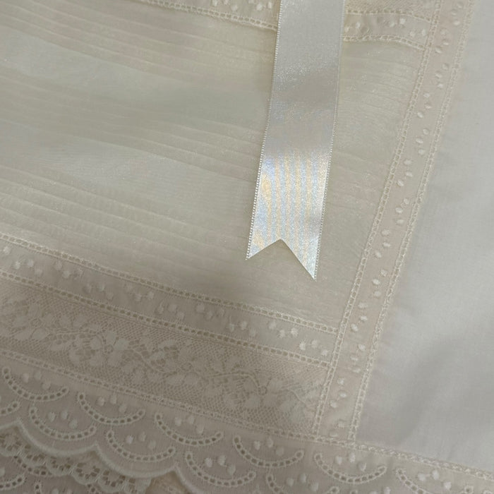 Close-up of beige lace and satin ribbon detailing on Luz Ivory Faldon Skirt