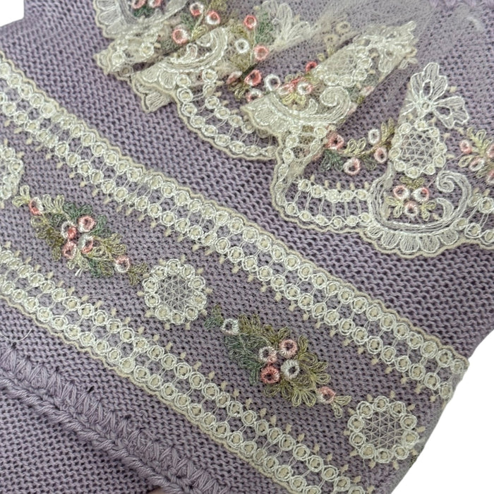 Close-up of pink floral embroidery and ivory lace on Aida Purple knitted set
