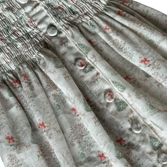 Close-up of soft gray Christmas print fabric with delicate red holiday details
