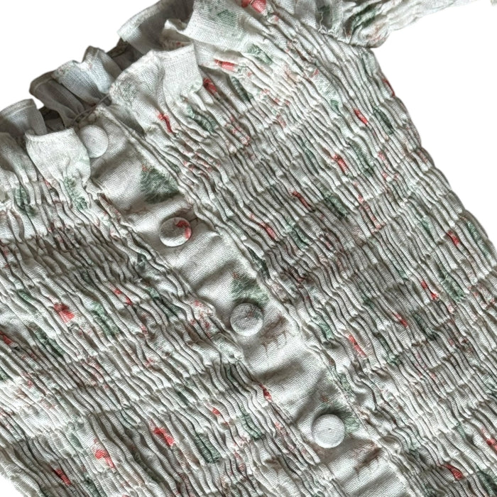 Close-up of smocked bodice detailing on Piccoli & Co Christmas nap dress