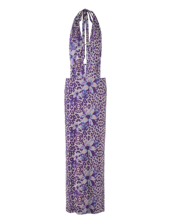 A form-fitting MAGDALENA MAXI DRESS - PURPLE : BY POPPY LEOPARD from TIGERMIST, featuring a sleeveless, halter-neck design with a deep plunging neckline, adorned with a purple leopard print and large blue flowers.