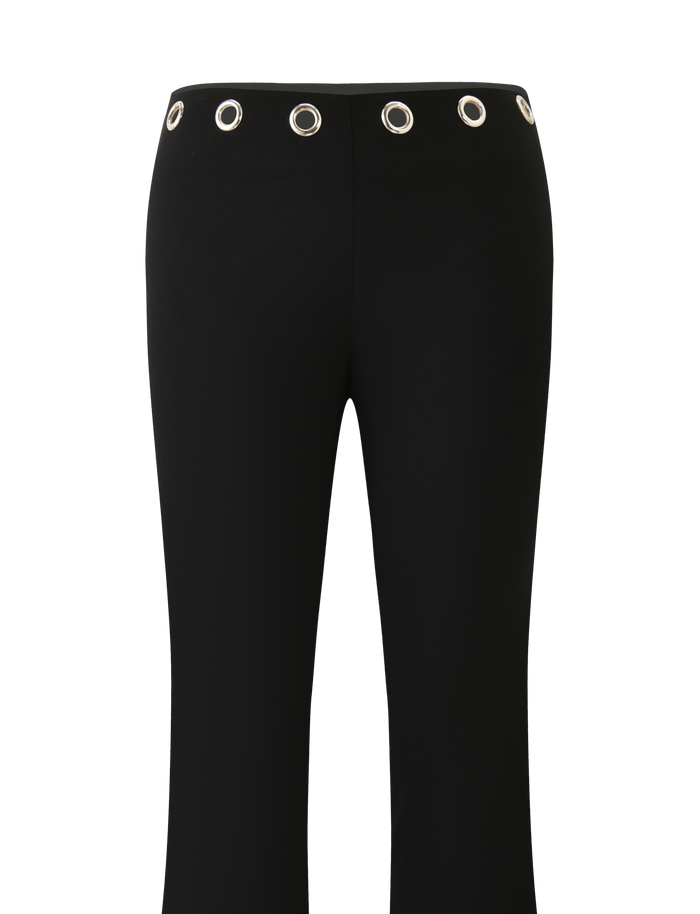 The TIGERMIST MARREN PANT - BLACK features a straight fit, low-rise waist, and bold silver grommets evenly spaced around the waistband. Shown against a plain white background.