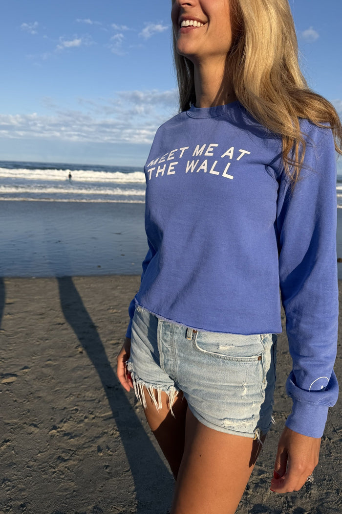 Meet Me At The Wall periwinkle sweatshirt front on model at the beach
