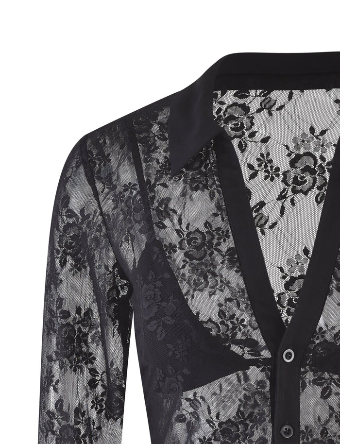 A close-up view of the TIGERMIST MIRABEL TOP - BLACK : LACE, a sheer blouse adorned with floral patterns. This stylish piece features a collar, button-down front, and long sleeves, making its see-through design elegantly reveal an undergarment beneath.