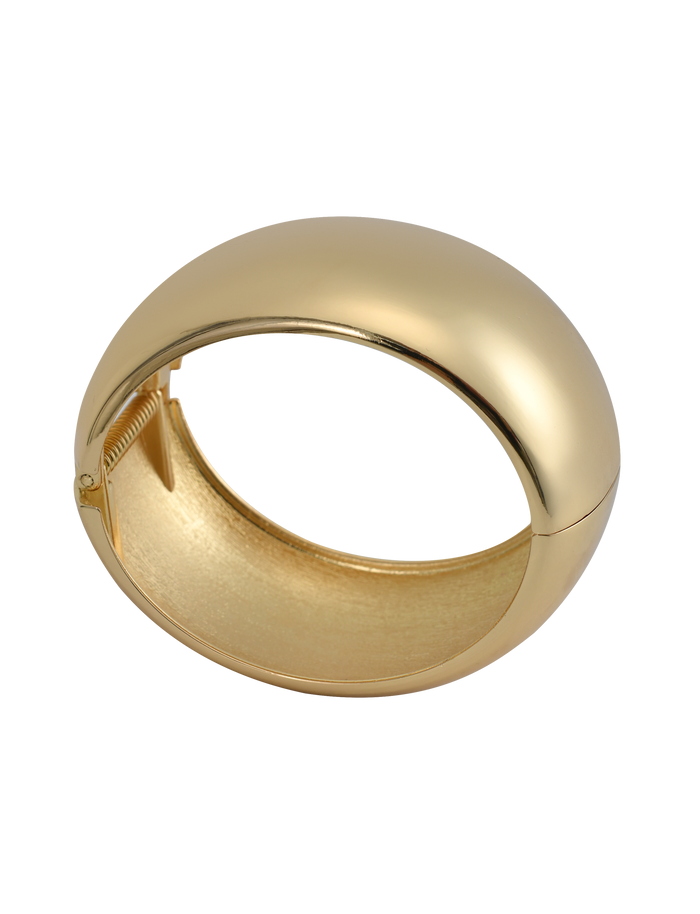 The TIGERMIST MIRAH CHUNKY BANGLE - GOLD features a smooth, shiny, domed gold cuff design with a hinge clasp, shown on a white background.