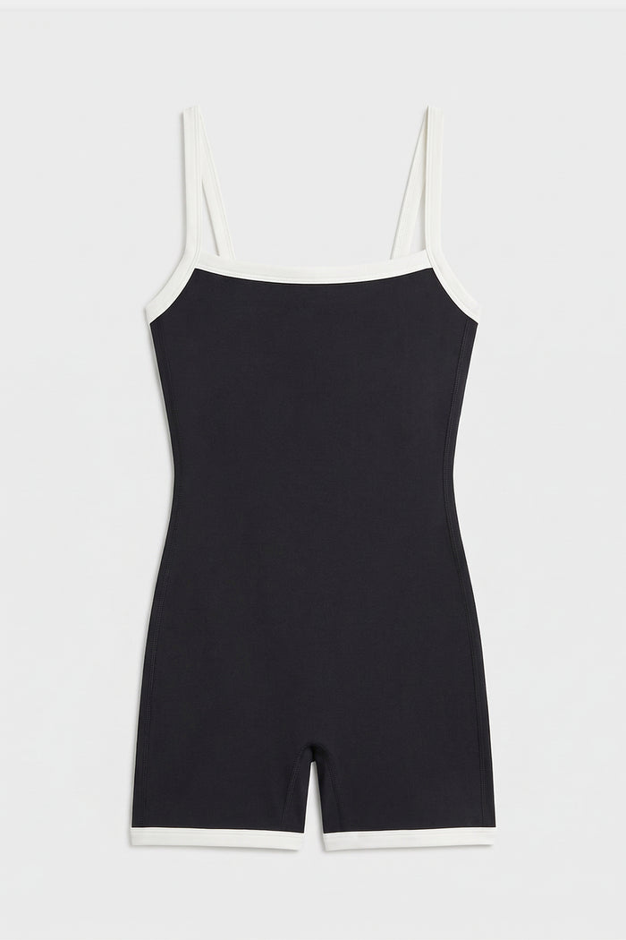 The SPLITS59 Monah Rigor Jumpsuit - Black/White is a sleeveless one-piece with white trim and a supportive fit, shown flat on a white background.