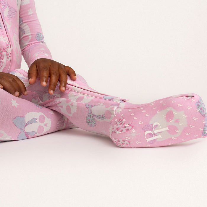 Close-up of a child's sleeve in the Posh Peanut Ms. Kelly Convertible One Piece, white background