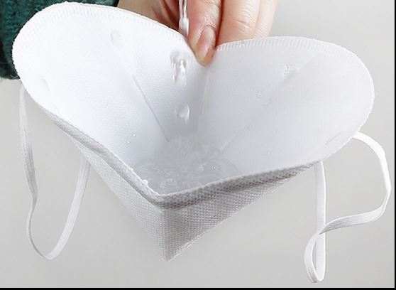 Inside view of white KN95 face mask held open