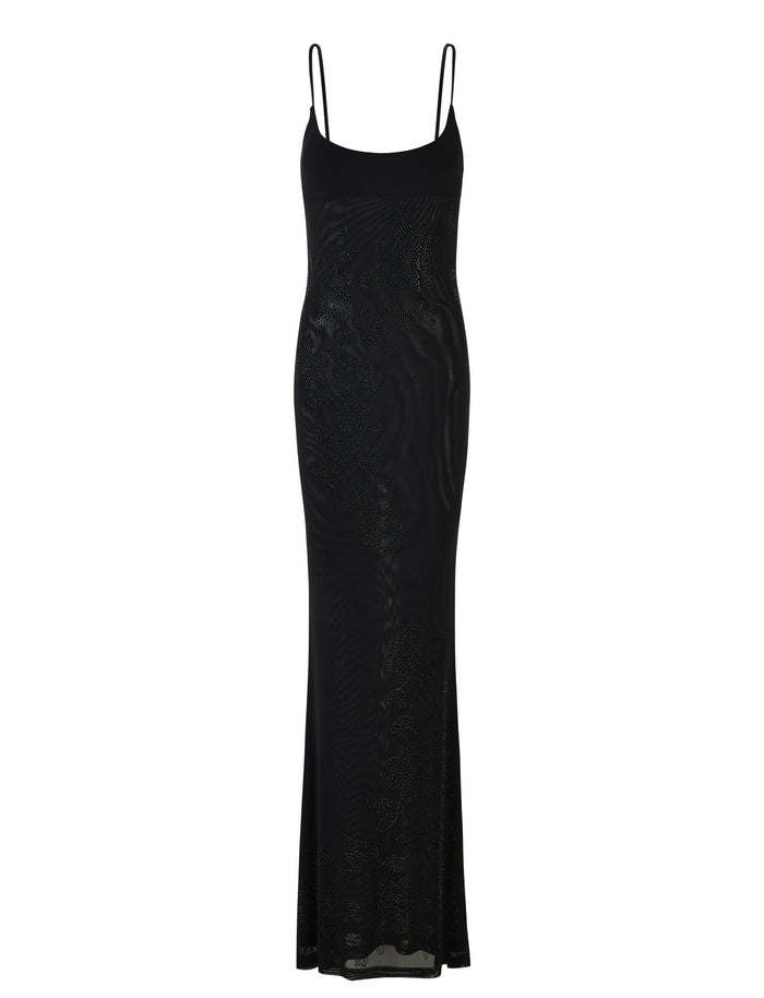 An elegant full-length OCTAVIA DRESS - BLACK from TIGERMIST, designed with thin spaghetti straps and a sleek silhouette, featuring subtle shimmering patterns that add texture to the fabric.