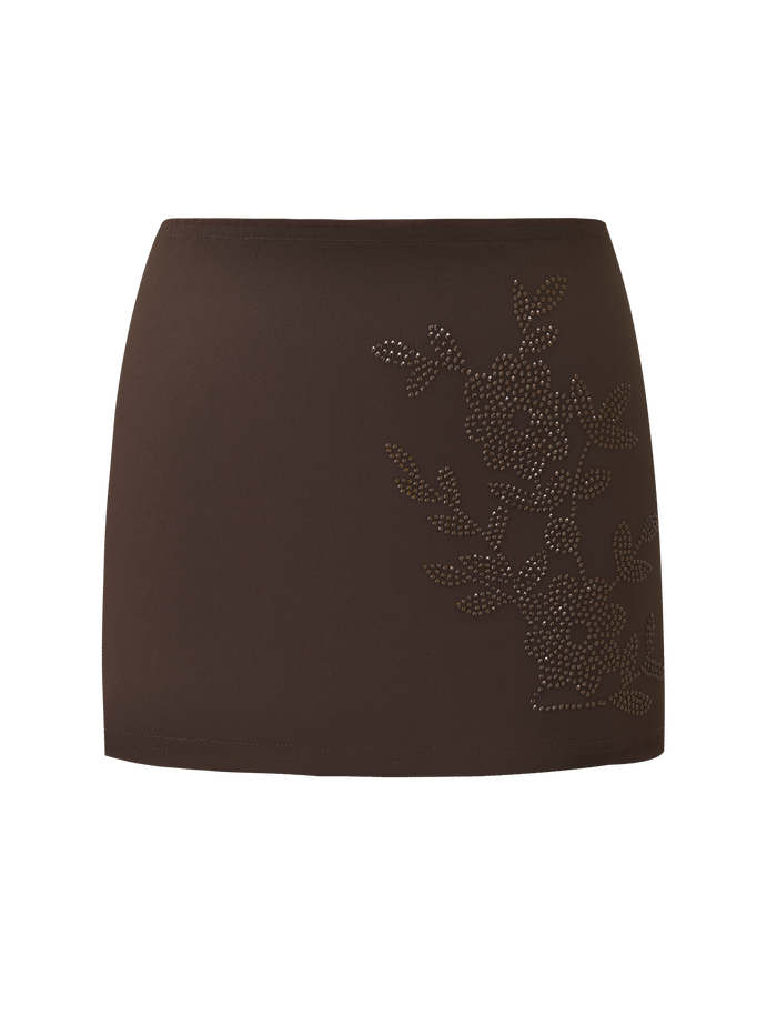 The Tiger Mist CL - OCTAVIA MINI SKIRT is a brown mini skirt with a floral pattern of small, shiny studs on one side.