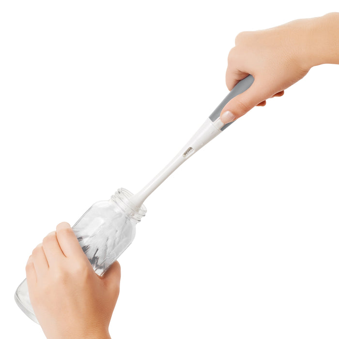 Bottle brush with gray handle from Oxo Tot Bottle & Cup Cleaning Set, perfect for toshi baby romper cleanup