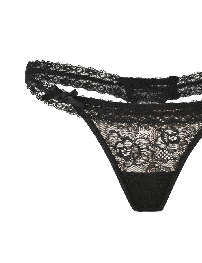 Black lace women's thong with floral patterns, scalloped edges, and a bow on the waistband—perfect to pair with the TIGERMIST PANDORA SET - BLACK for a striking lingerie ensemble.