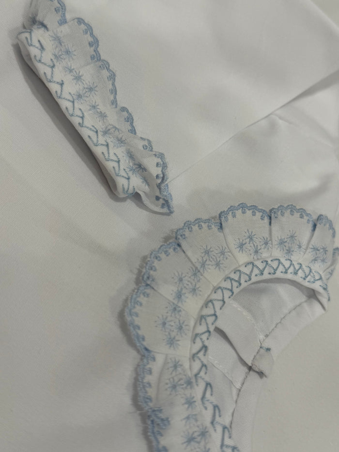 Close-up of blue embroidered ruffle detailing on Paola Shirt