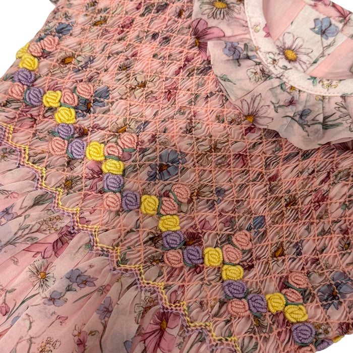 Close-up of colorful handsmocking and floral detailing on Floral Gleam Pink Organza Dress