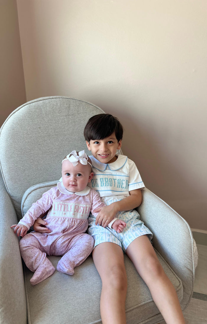 Children wearing coordinating Little Sister and Little Brother footie babygrows