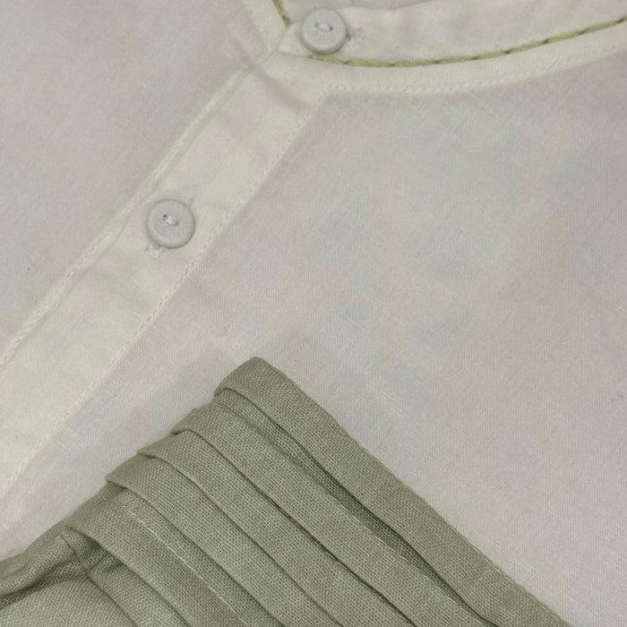 Close-up of ivory long-sleeve shirt and integrated cummerbund detailing on TPWC Page Boy set