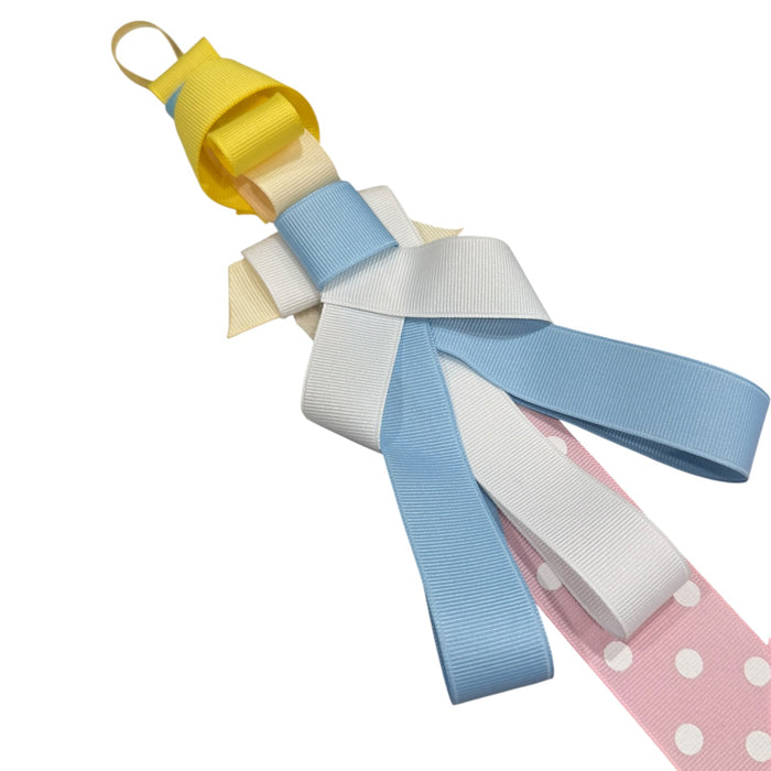 Close-up of blue and yellow princess-inspired bow clips on ribbon hanger