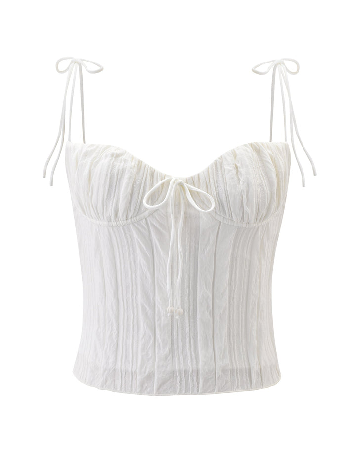 The RANIA TOP - OFF WHITE by TIGERMIST is a corset-style top with strappy shoulders, a front tie detail, crinkled fabric, and vertical seams for a fitted look.
