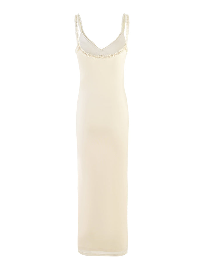 The Rayla Dress - White : Cream from Tiger Mist is a sleeveless, form-fitting dress with a knee-length hem. It features thin straps and a delicate trim along the neckline and armholes. The fabric has a smooth, slightly sheer texture.