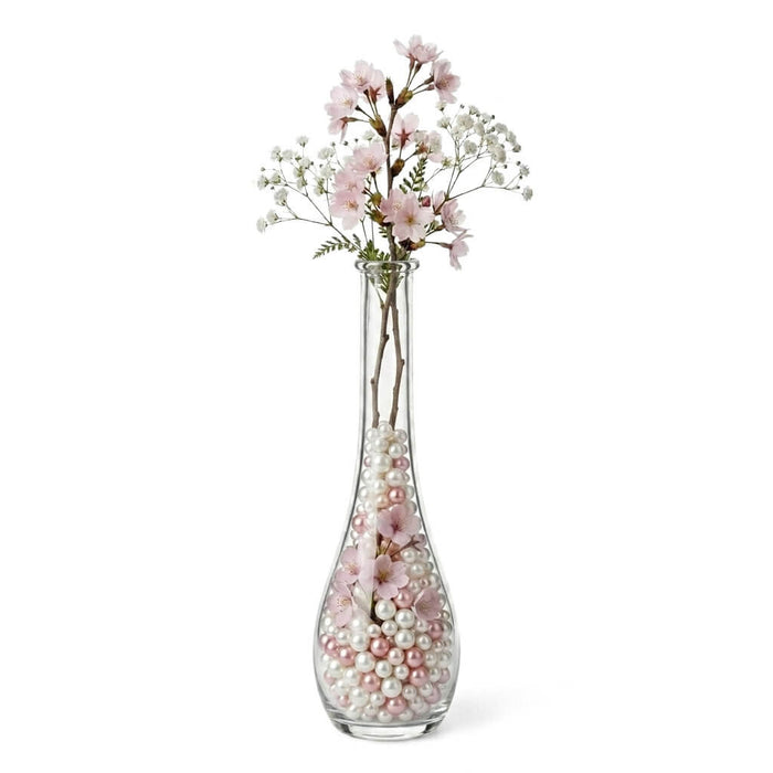 7" Clear Round Teardrop Bud Vase filled with pearls and pink blossoms on a white background