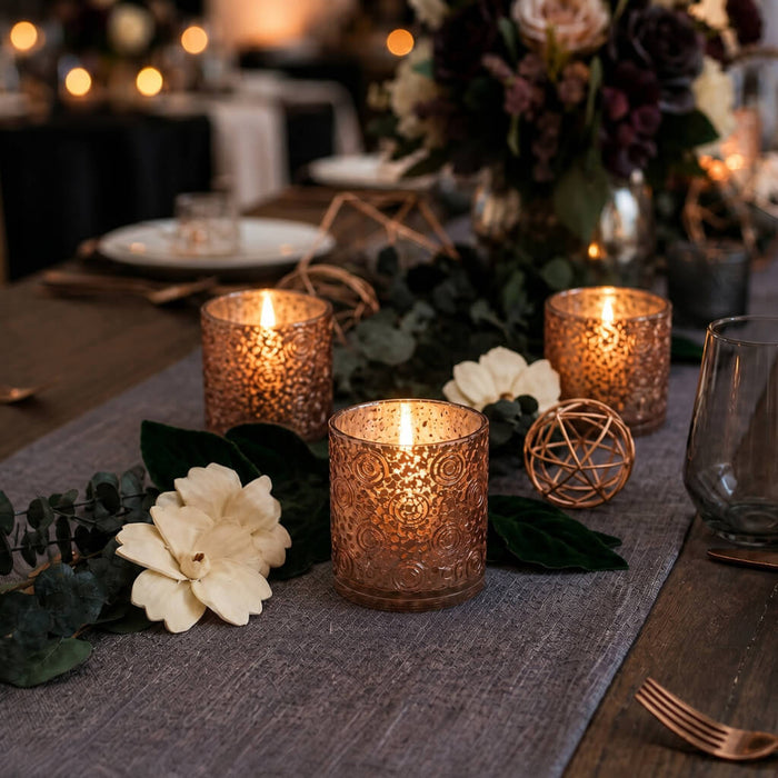 Rose gold mercury candle holders on elegant floral dinner table centerpiece