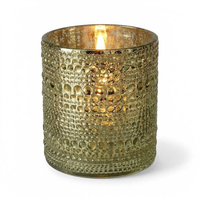 Pearly metallic gold mercury candle holder with glowing light on white background