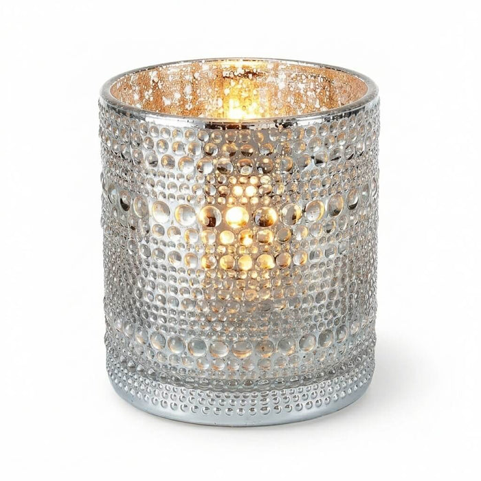 Pearly silver candle holder with glowing light on white background