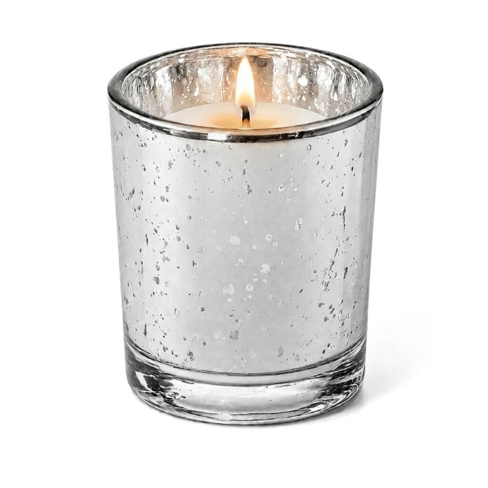 A Silver Mercury Votive Holder with lit candle on a white backdrop