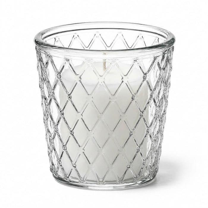 An unlit white pillar candle inside a clear glass Tipper Vase & Candle Holder