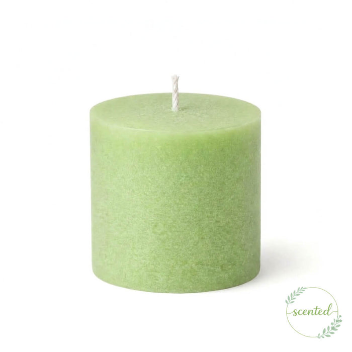 Green scented votive candle on a white background