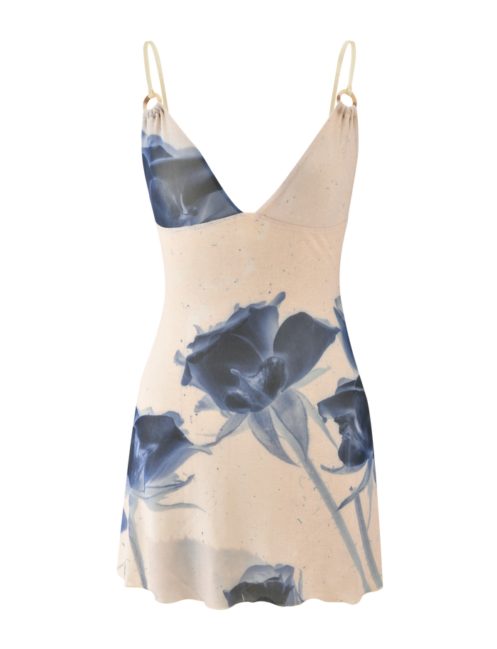 The TIGERMIST ROSY MINI DRESS - INDIGO FLORAL is a sleeveless cream mini dress featuring adjustable cami straps and a striking indigo floral print.