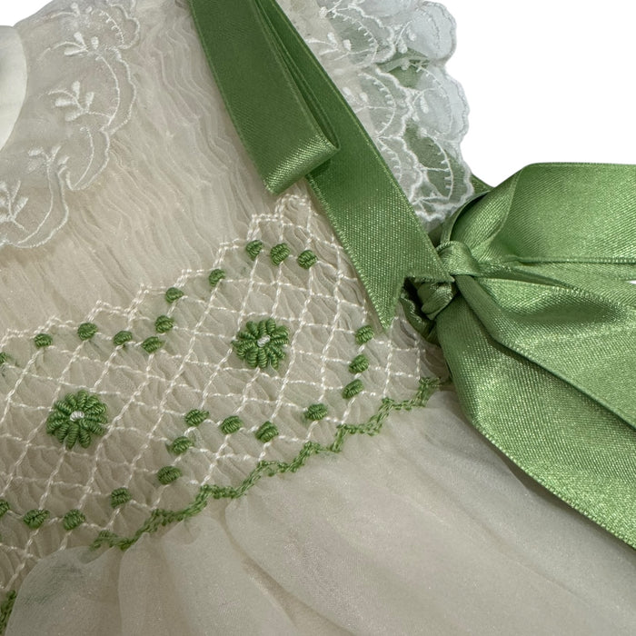 Close-up of lime green handsmocking and ribbon bow on Sasha Ivory Dress