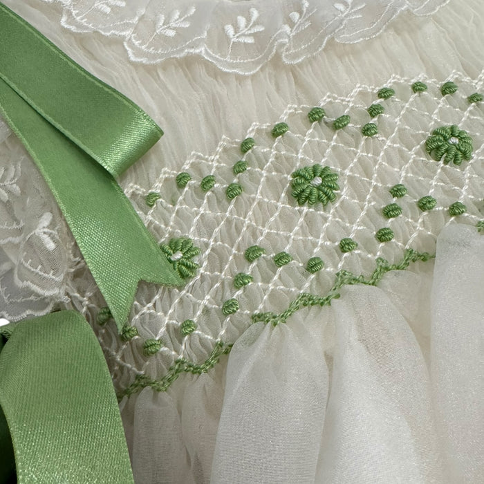 Close-up of hand-embroidered detailing and lime ribbon on Sasha Handsmocked Dress
